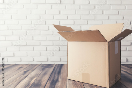 empty open box on white brick wall background with space for inscription