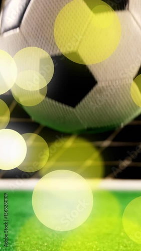 Animation of falling glowing lights over football ball