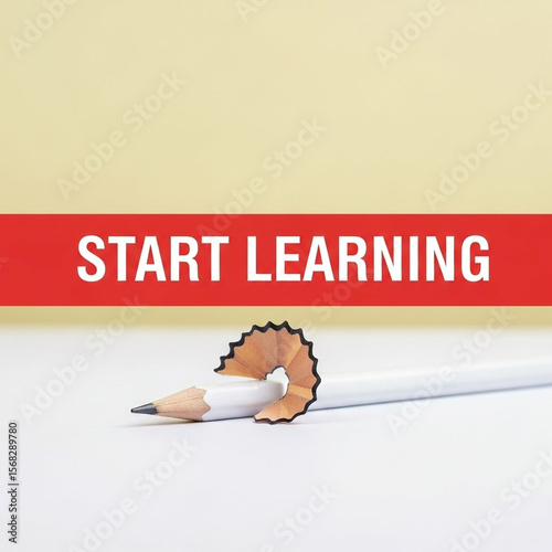 Start learning message on red stripe with pencil shavings and white pencil