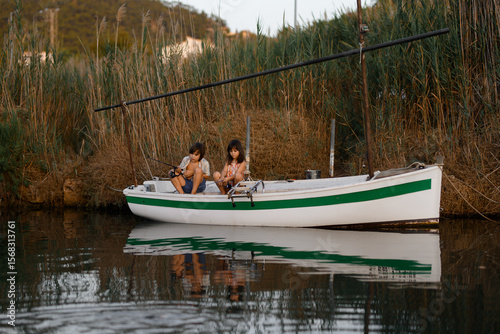 Children fishing on a tranquil riverboat adventure