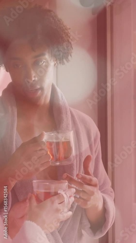 Drinking tea and talking, couple in bathrobes with bokeh lights animation