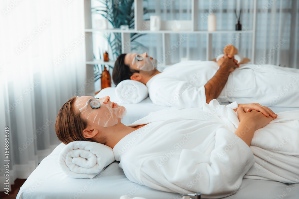 Obraz premium Serene daylight ambiance of spa salon, couple customer indulges in rejuvenating with luxurious cucumber facial mask. Facial skincare treatment and beauty care concept. Quiescent