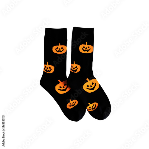Pair of black socks with an allover pattern of orange jack o lanterns isolated on transparent background