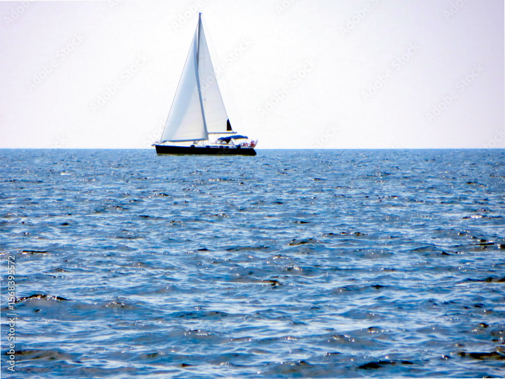 Obraz premium Sail Yacht Gliding Across Calm Waters Under a Bright Sky During a Serene Afternoon