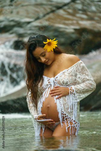 pregnant young girl modeling in the river