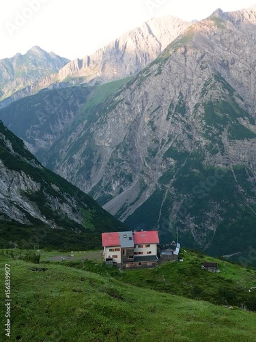 Vertical Mountain hut aerial reveal in austrian alps during sunrise_1