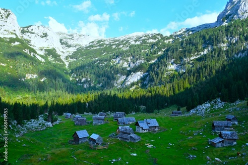 View of Laz mountain pasture with wooden huts in Julian alps, Gorenjska, Slovenia