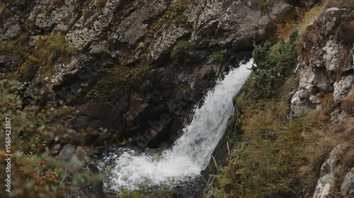 A stormy mountain river, a powerful stream flows down the boulders.