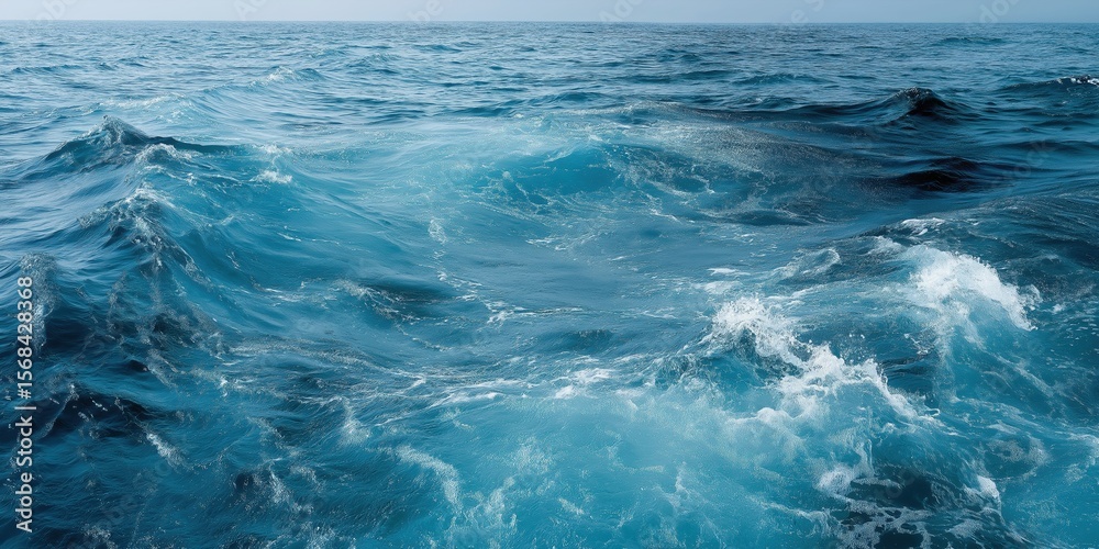 Fototapeta premium Vibrant ocean waves with crisp blue water under clear sky