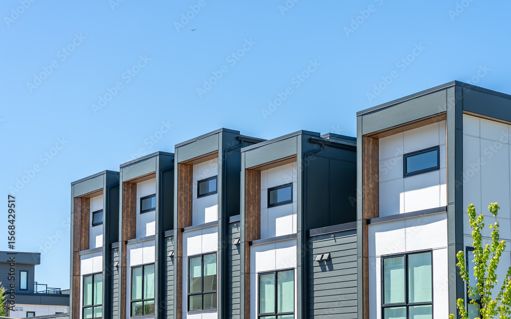Obraz premium Top of modern apartment building with balcony, trees and beautiful landscape in Vancouver, Canada, North America. Day time on June 2025.