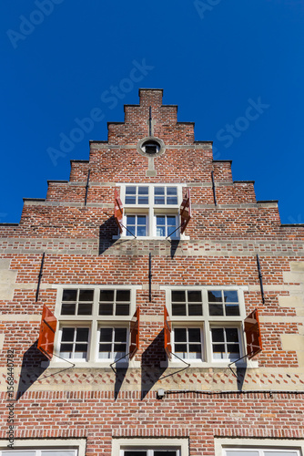 Historic house with shutters and step gable in Den Bosch, Netherlands