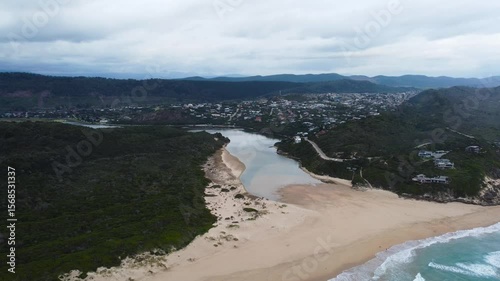 The coastal town of Sedgefield on the Garden Route camera moving from the ocean over the lagoon 4K Aerial Video.
