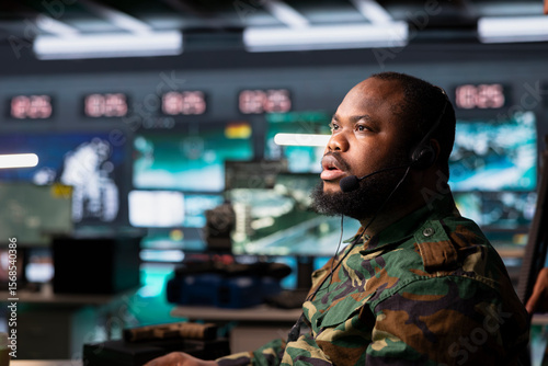 Military dispatcher using headphones microphone, offering information to commanders fighting on front lines. Army specialist providing intel for troops in base of operations