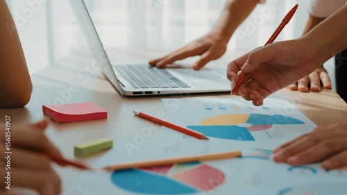 Startup company employee working together using laptop analyzing BI dashboard paper on financial data report and planning strategic marketing for creative business success in panorama video. Synergic