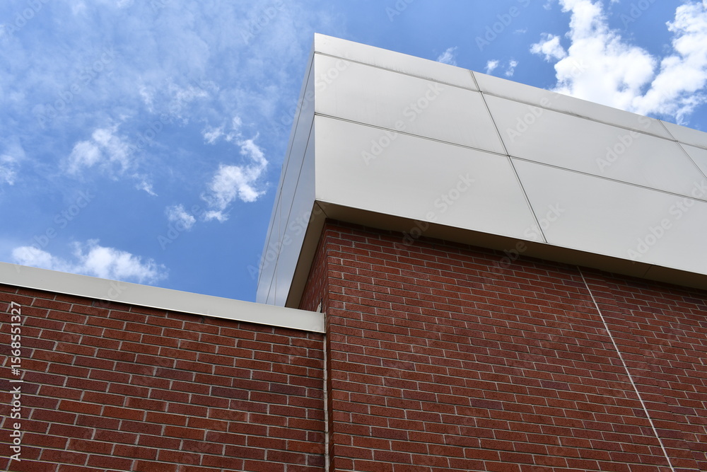 Obraz premium Large government building. Cement and brick construction. Beautiful blue sky.