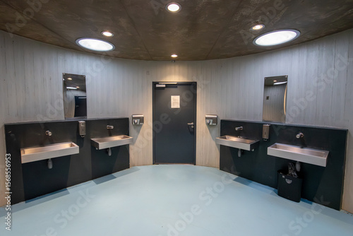 The building has organic shapes that completely contradict the conventional perception of public toilets. It consists of three intersecting circles. Is completely clad with wooden battens.