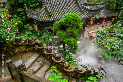 Chinese architecture with a mossy tile roof is showcased at Huangling Village in Wuyuan, Jiangxi, China. Ornate gardens and flowing water features give a glimpse into ancient Chinese culture