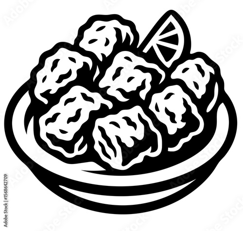A plate of chicharron with a lemon wedge on it.