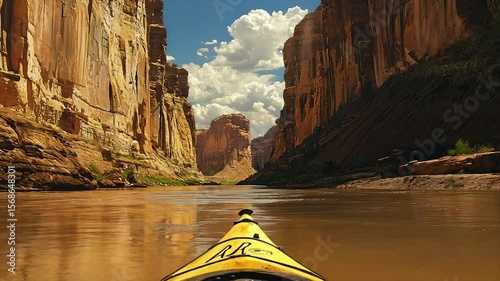 Kayaking through a stunning canyon.  Vast, sandstone walls, calm river, bright sunlight, and a sense of adventure