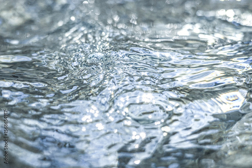 The shimmering dance of light and shadow on the clear water surface