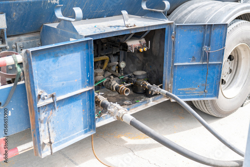 Connecting a gas hose from the truck to the storage tank.