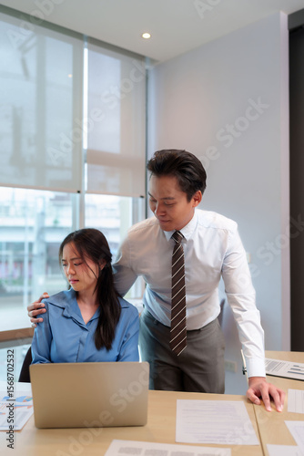 Принти на полотні Asian business man inappropriately touches young Asian woman employee office sex
