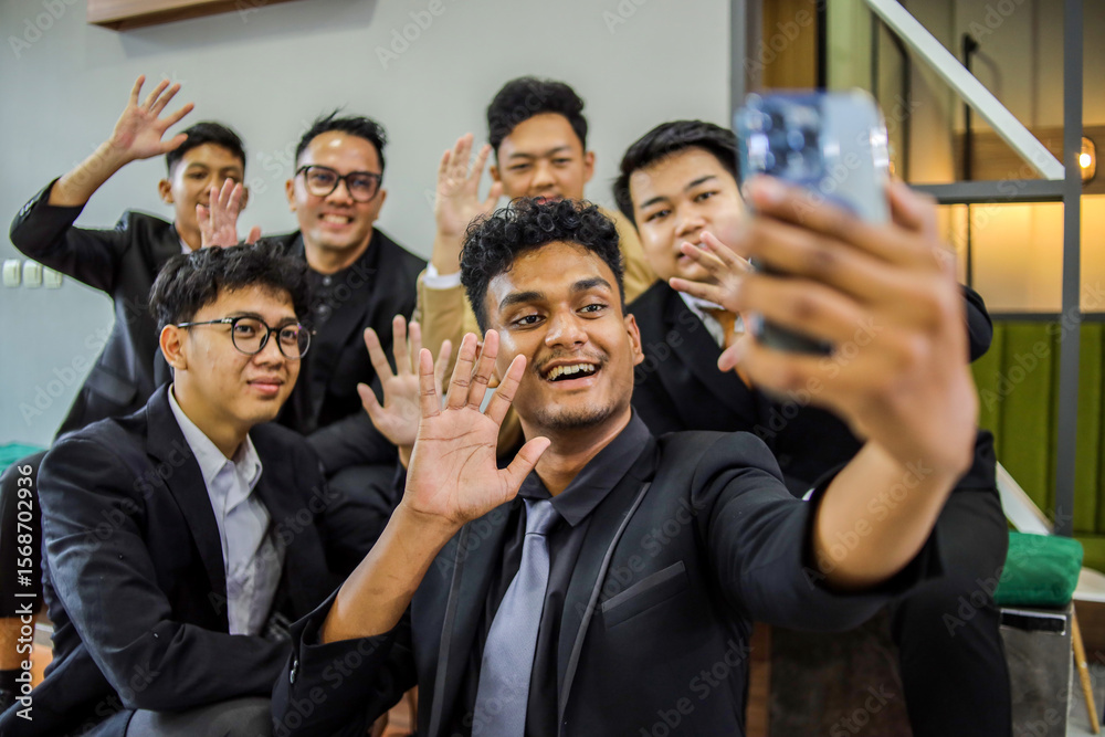 Obraz premium Cheerful Group Of Diverse Male Professionals Taking Selfie With Waving Hand Together