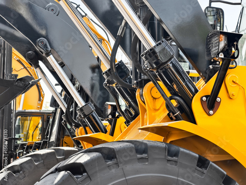 Heavy machinery working at a construction site with hydraulic systems displayed clearly during daytime