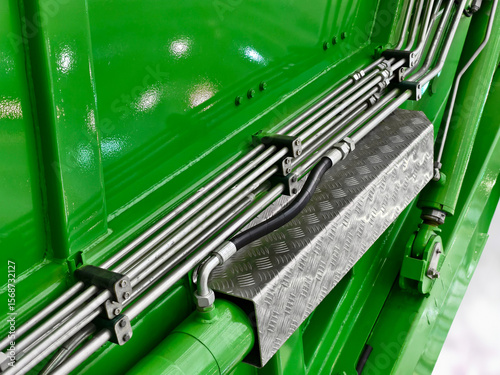 Detailing the vibrant green machinery with chrome accents and patterned surfaces, showcasing industry innovation and craftsmanship in a close-up view