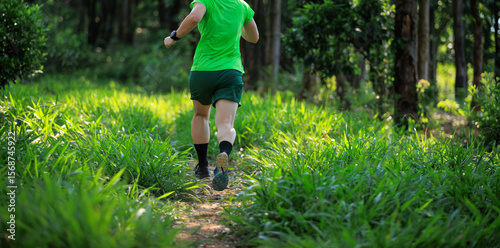 Canvas Print Woman trail runner running at tropical forest mountain peak