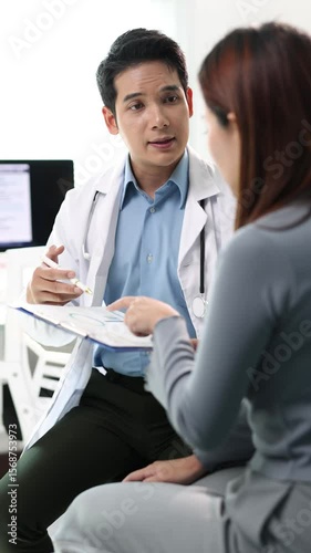 Professional doctor explaining diagnosis to female patient suffering cough and chest pain while sitting on examination bed in clinic, healthcare and medical concept.
