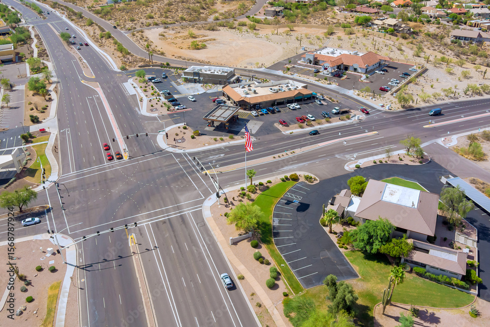 Fototapeta premium Complex multi lane roadways intersection with commercial buildings, parking lots, landscaped areas in Fountain Hills, Maricopa County, Arizona