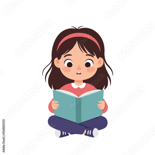 A young girl with brown hair and a pink headband sits cross-legged while reading a blue book.