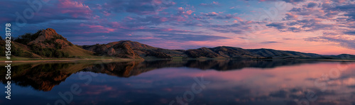 The lake reflects pink - purple clouds and mountains, with soft and quiet tones, showing the beauty of the dusk lake scenery, suitable for nature and scenery themes.