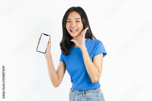 Smiling asian woman holding smartphone with blank screen for advertising on white background.