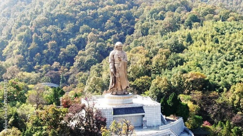 Laozi Taoist sculpture in scenic landscape showcases ancient philosophy and art