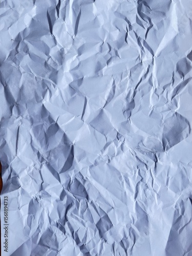 Wrinkled Texture: An abstract overhead shot of a crumpled piece of paper, showcasing its intricate folds and textures.