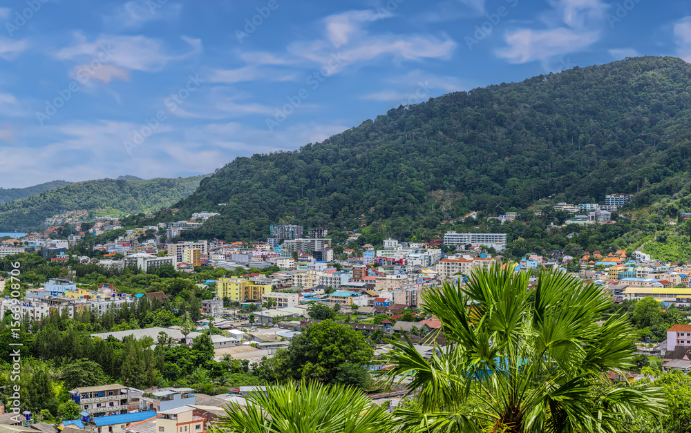 Obraz premium view of Patong and Patong Beach from the mountains colourful skies at Sunset. Patong is a vibrant city full of tourists from all around the world.