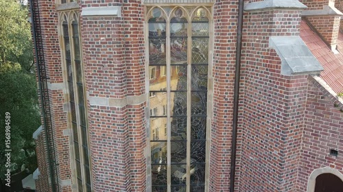 Large window of Garrison church in Wroclaw, Poland. Tall church built with red bricks.