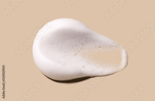 texture foam mousse foam cosmetic smear sample on beige background