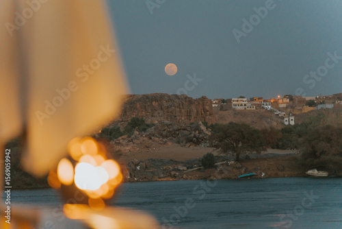 Papier peint Romantic dinner on a cruise ship with full moon over nile river in egypt