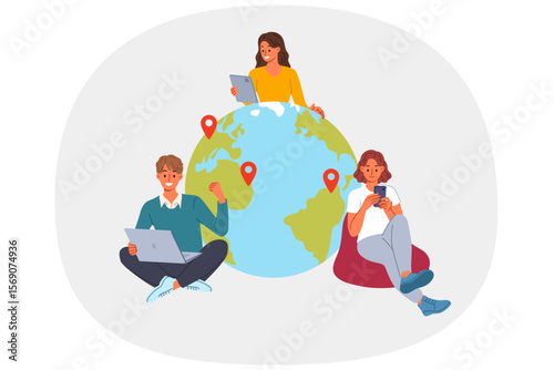 Team of business people works remotely from different countries, sitting with gadgets near globe. Team of two women and man uses internet to connect with friends on other continents