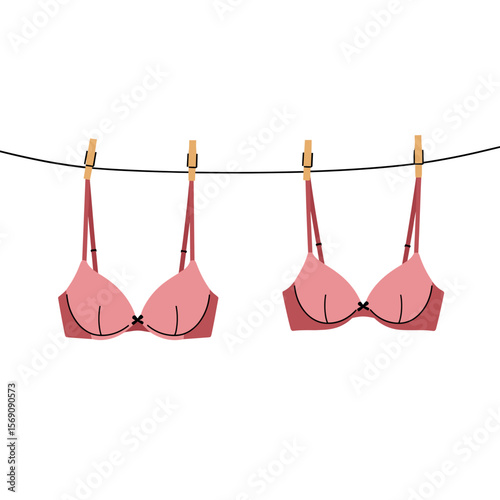 Colorful bras hanging on a clothesline against a white background  