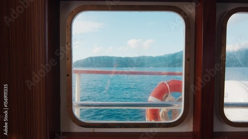 Boat moves in the sea. Life buoy and window of the boat