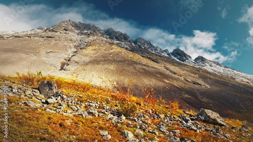 Autumn valley with snow capped mountains in the Khibiny Mountains in Russia