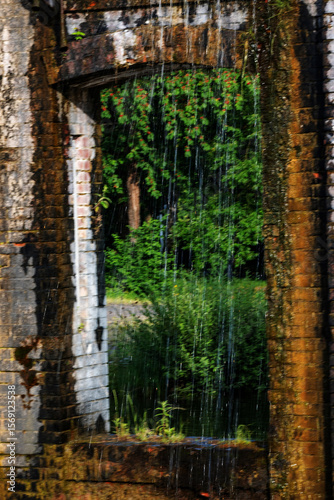 Waterfall in an old abandoned building. The concept of environmental protection.