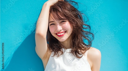 Vibrant Young Woman Smiling Against Bright Blue Wall