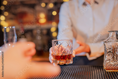 Tableau sur toile Professional female bartender preparing alcoholic drinks in a bar