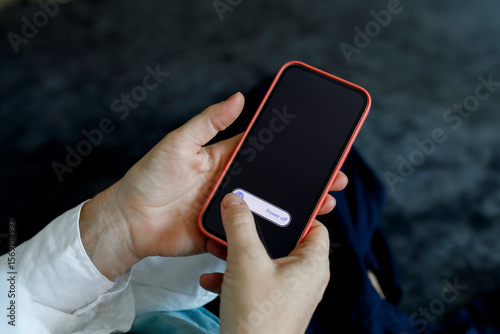 Woman switching off mobile phone at home