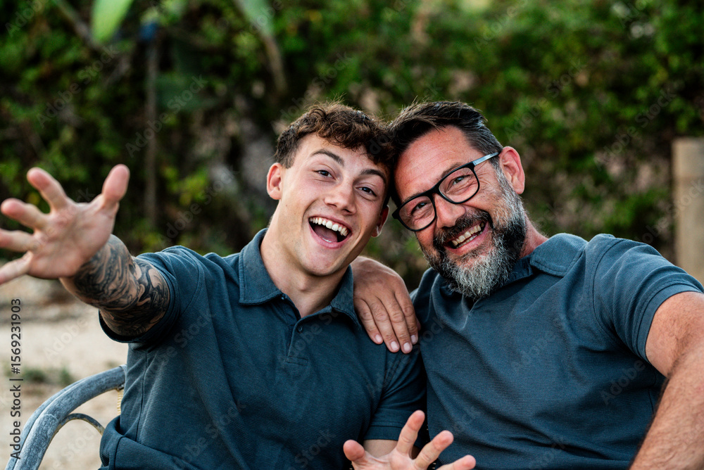 Fototapeta premium Happy father and adult son spending quality time outdoors – multigenerational bonding, friendship, family connection and leisure moments together